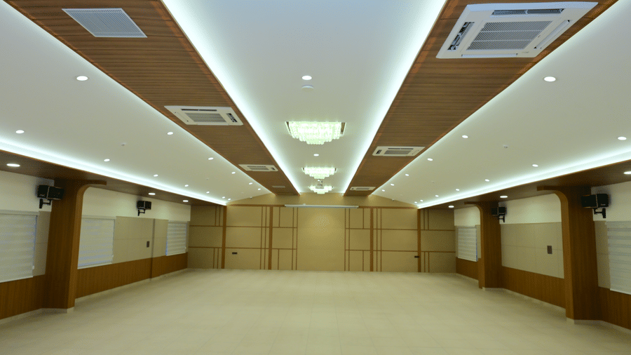 Banquet hall of Bhavanis Vista By Icon featuring an empty floor and corner ceiling lighting.