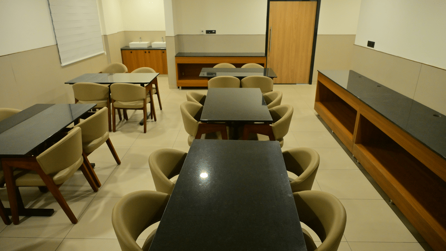 Banquet hall of Bhavanis Vista By Icon featuring tables and chairs arranged for seating.