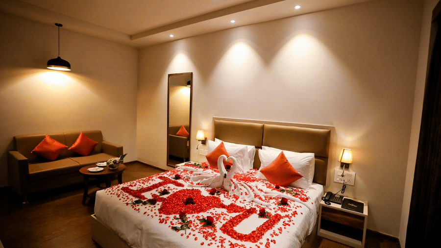 A bed with flower petals arranged on it at Amara Grand Baga, Goa.