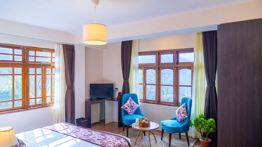 Dream Villa Retreat, Pelling - Interiors of the room with a comfortable bed, two chair, and a coffee table 