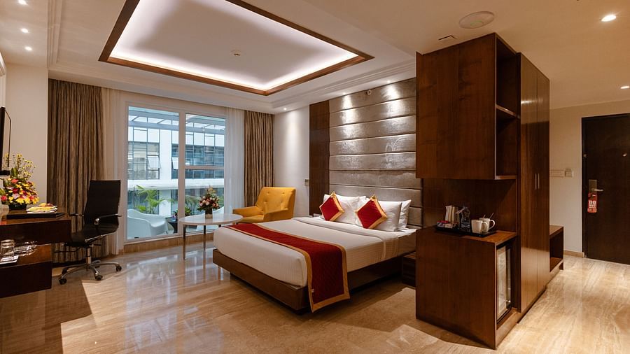Spacious side view of executive room with a king-size cozy bed and interior lighting at Icon Premier Hotel by Bhagini, Devarabisanahalli