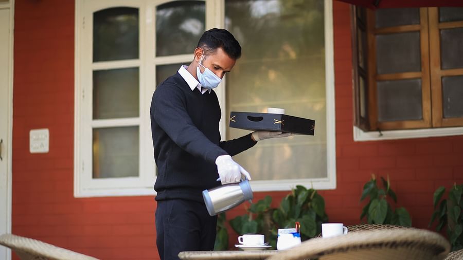 Butler pouring tea/coffee into a cup 1 - Lamrin Boutique Cottages Rishikesh