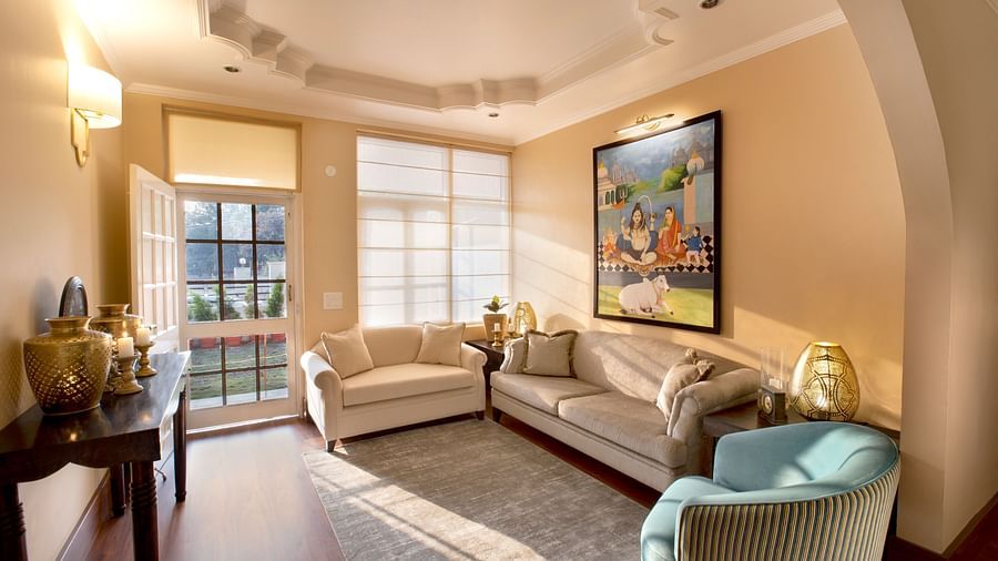 An image of a living room features comfy sofas and large windows 4 - Lamrin Boutique Cottages Rishikesh