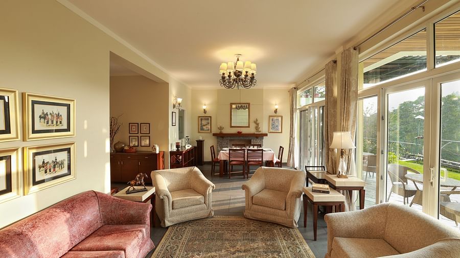 Aesthetically designed living room with painted with pastel hues and features couches facing the outdoor landscapes4 - Lamrin Norwood Green Palampur