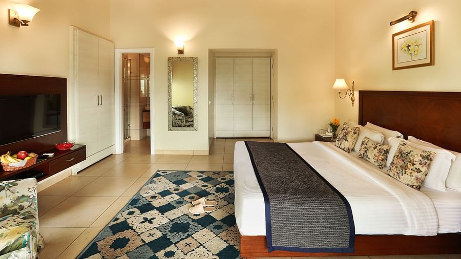 Full angle view of Super deluxe room featuring a white cupboard and other room amenities like a television, a tea & coffee maker, among others - Lamrin Norwood Green, Palampur