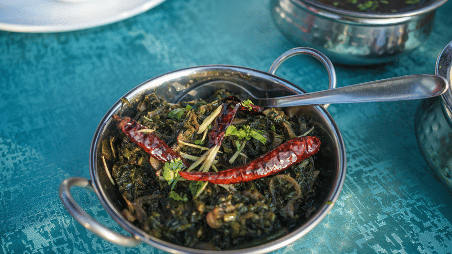 A close up shot of an Indian leafy dish | Sol Glow Resort, Nainital
