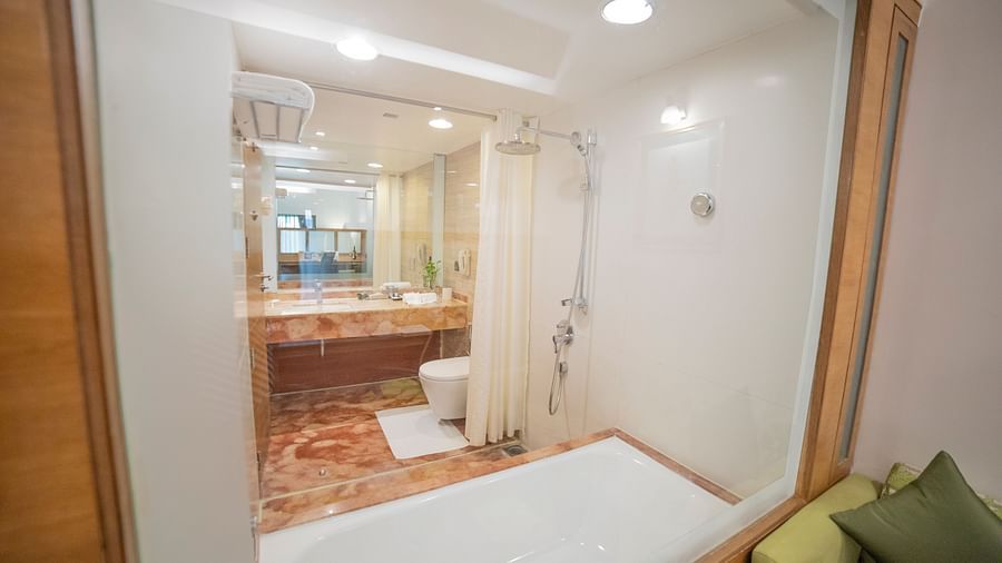 mirror and beds in suite room - The Orchid Hotel Pune