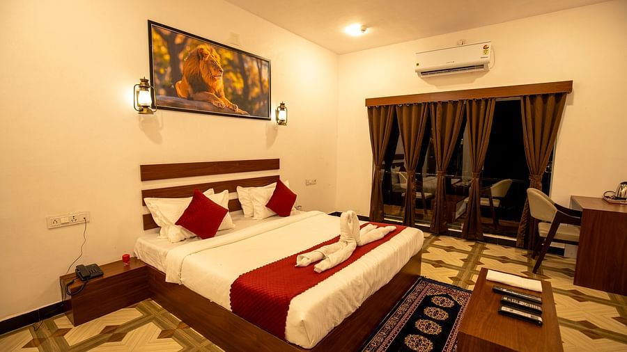 interiors of the suite featuring a double bed and a centre table in front of it - VITS Select Diamond Resort, Sasan Gir