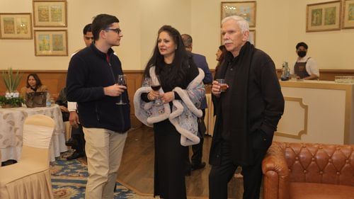 An image of three people of different age groups gathered in an event at Heritage Village Resorts & Spa