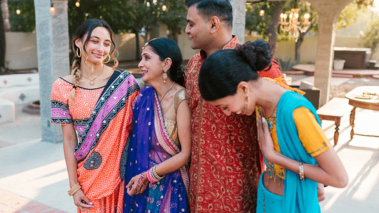 A family of four posing for a photo in the courtyard