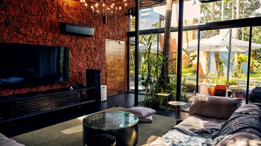 A luxurious living room with a sofa in front of a television at Villa In Palms by V Escapes