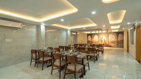 Elegant dining area with neatly arranged tables and chairs at Perfectstayz Premium Krishna Abode, Vrindavan