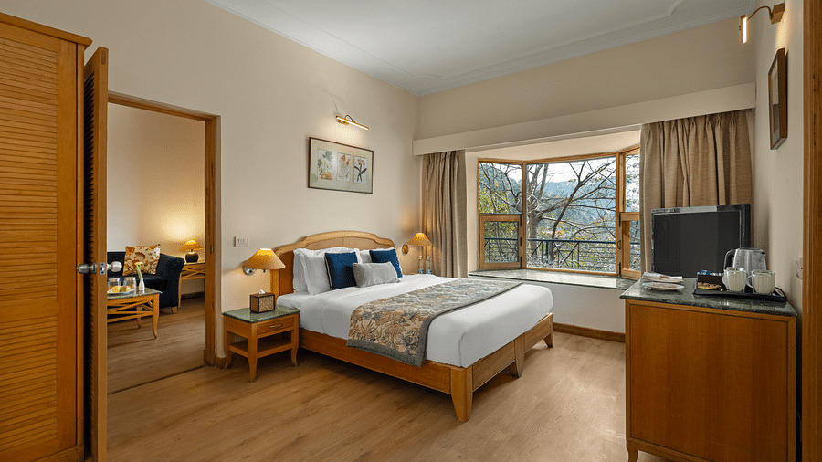 Superior Cottage Hill View with comfy bed, Tv, and window with a beautiful view at Baikuth resort, kasauli.