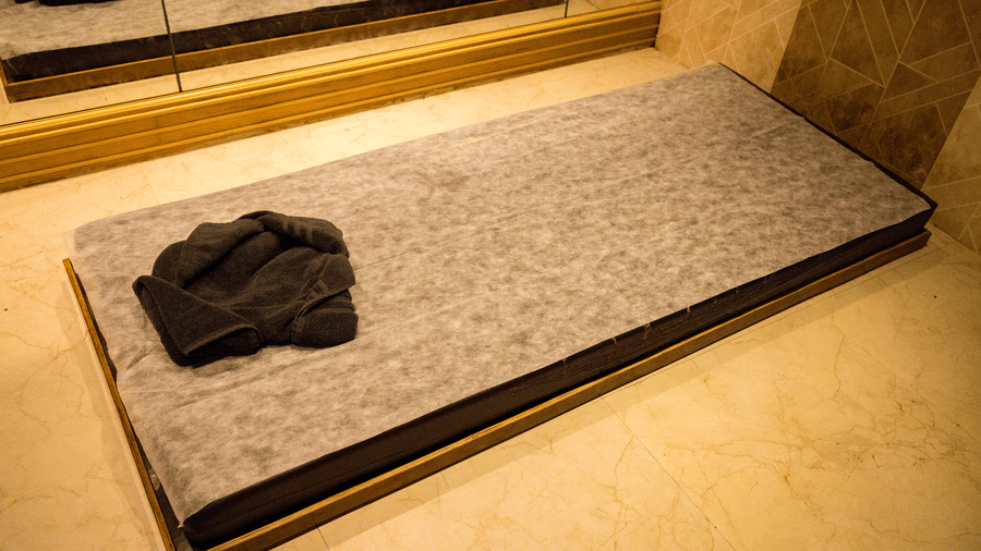 Top view of the mattress kept on the floor with a towel placed over it at the Benzz Park, Vellore.