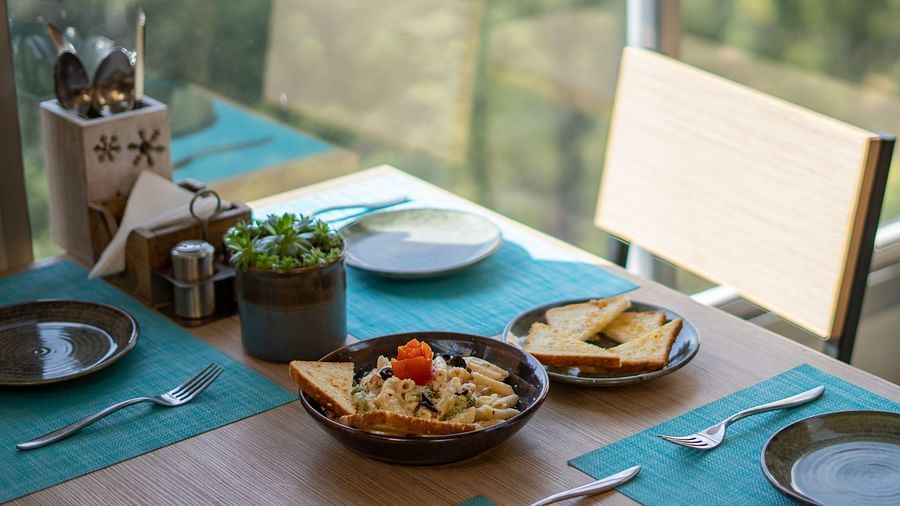 A dish placed on a table with cutlery arranged beside it at BluSalzz Escapade Resort, Lansdowne