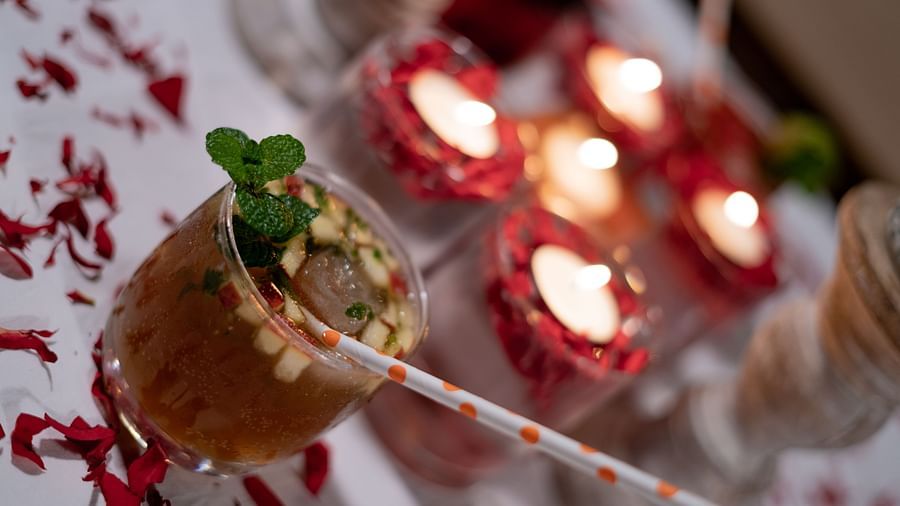 A drink placed besid glowing candles at BluSalzz Escapade Resort, Lansdowne.