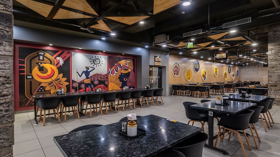 Wall art inspired by Indian culture and cosy seating at Highway King Restaurant.