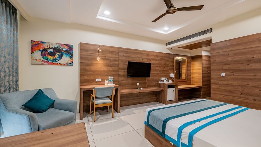 King size bed and cosy seating area in a modern room at Hotel Highway King, Bilaspur.