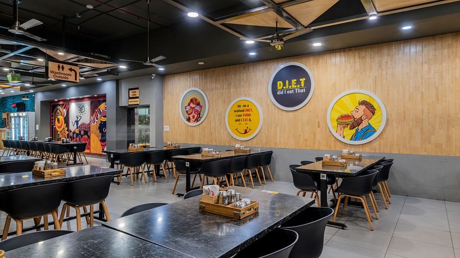 Modern casual dining section with warm lighting near the food counter at Hotel Highway King, Bilaspur.
