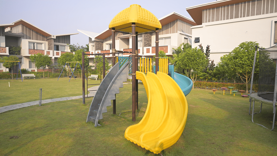 A spiral slide and climbing structure in the outdoor play area at Hotel Sonar Bangla, Mayapur.