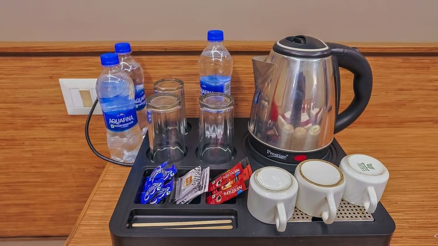 ea and water setup with cups and snacks at Max Hotel Prayagraj.