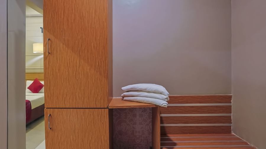 Closet with towels and storage shelves at Max Hotel Prayagraj.