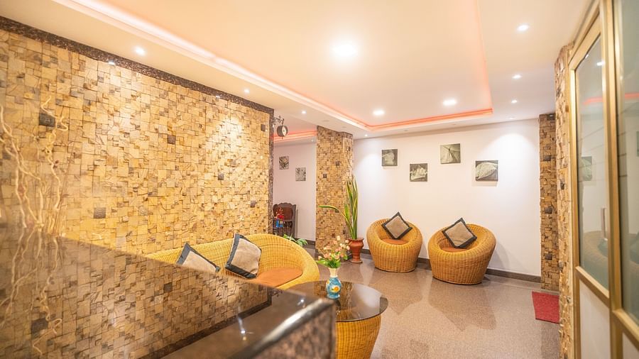 A seating area with ratan furniture at Parampara Residency, Kushalnagar.