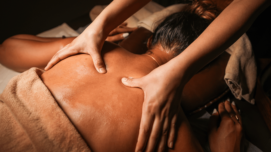Spa therapist giving a relaxing back massage.