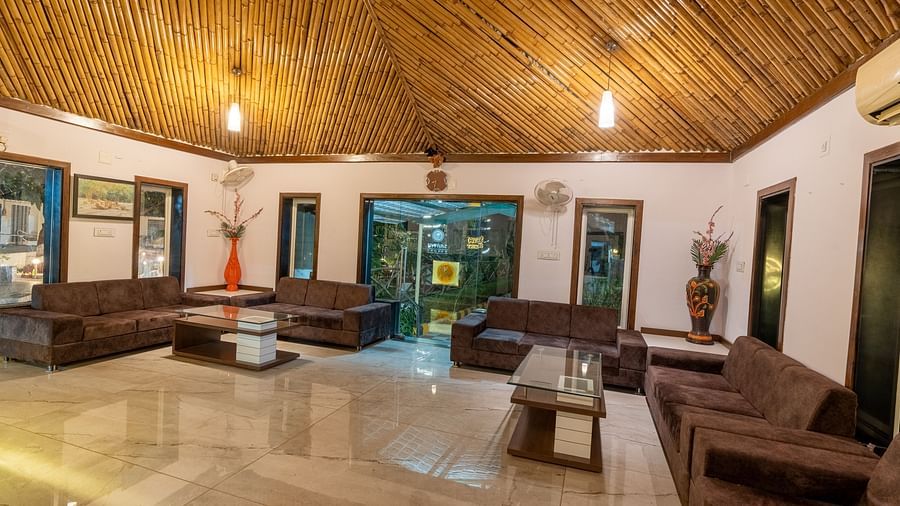 The lobby area with sofas, glass tables, and a bamboo-covered ceiling.