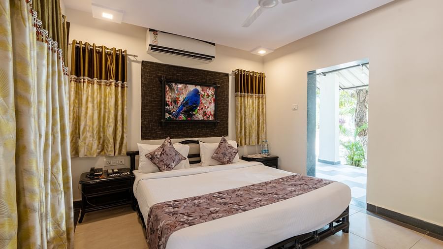 A room with with a double bed and side tables at Saavaj Resort