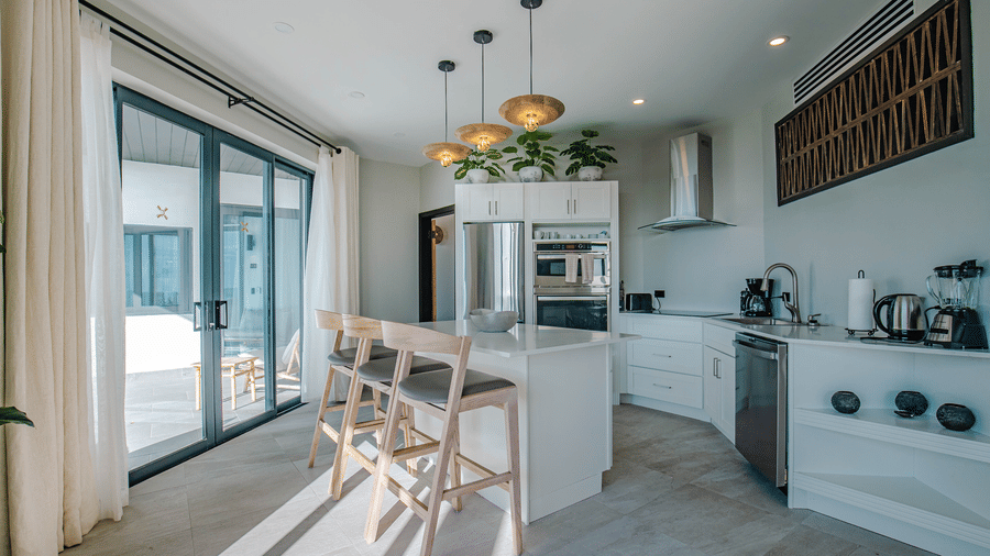 A kitchen and dining area with a table, chairs, and appliances at Tamarind Hills Resort and Villas, Antigua.
