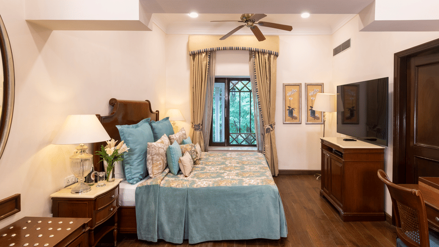 image of the Deluxe room with a king size bed and wooden flooring at The Claridges Nabha Residence