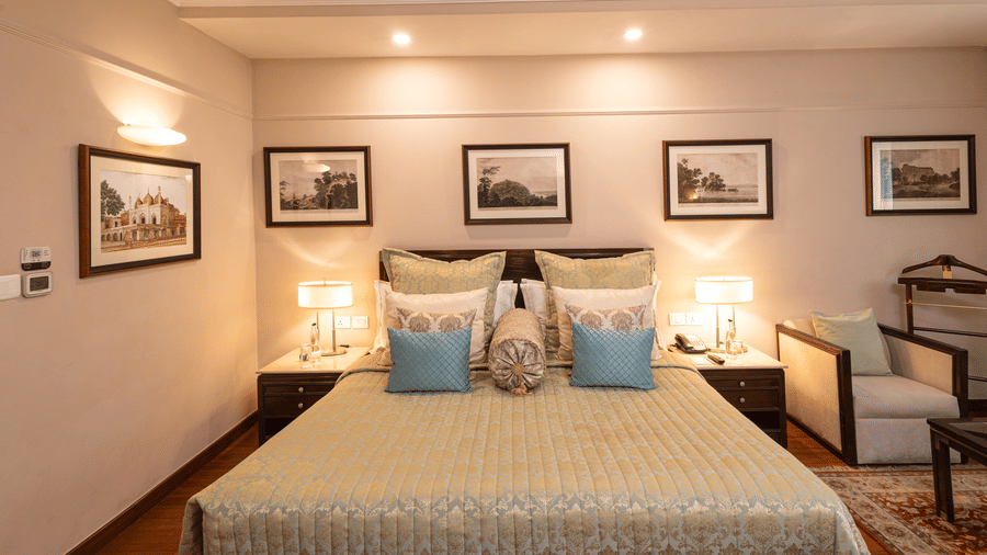 image of the boutique room featuring a king size bed with well kept pillows on it - The Claridges New Delhi