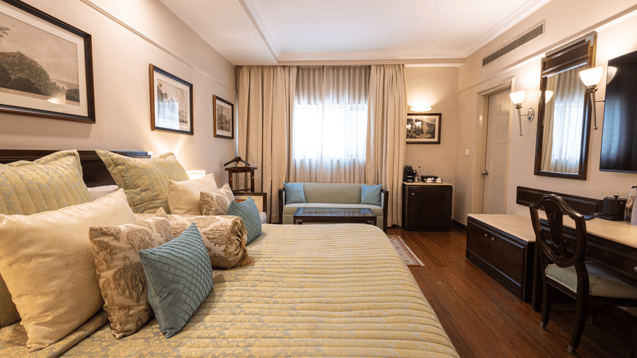 Image of a large bedroom featuring a king-size bed in our boutique rooms - The Claridges New Delhi