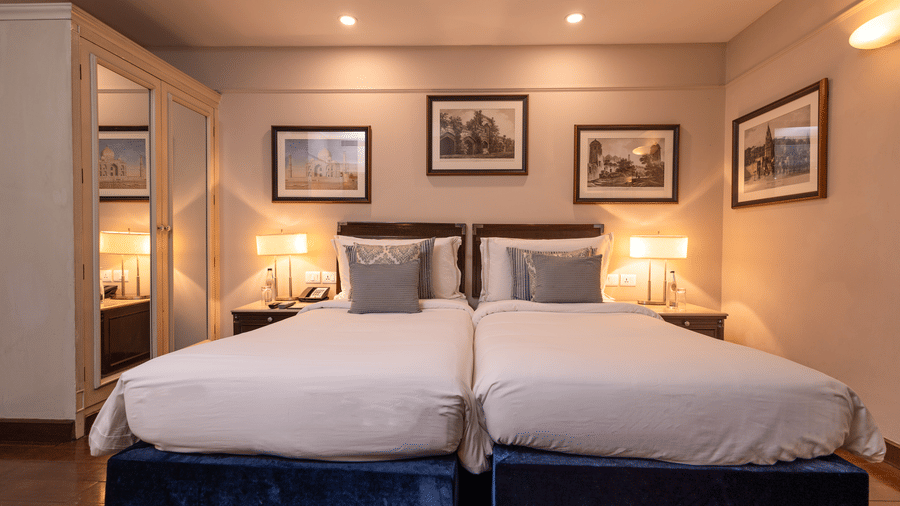 Front view of the Superior Twin Bed Room at The Claridges New Delhi, highlighting twin beds with bedside lamps