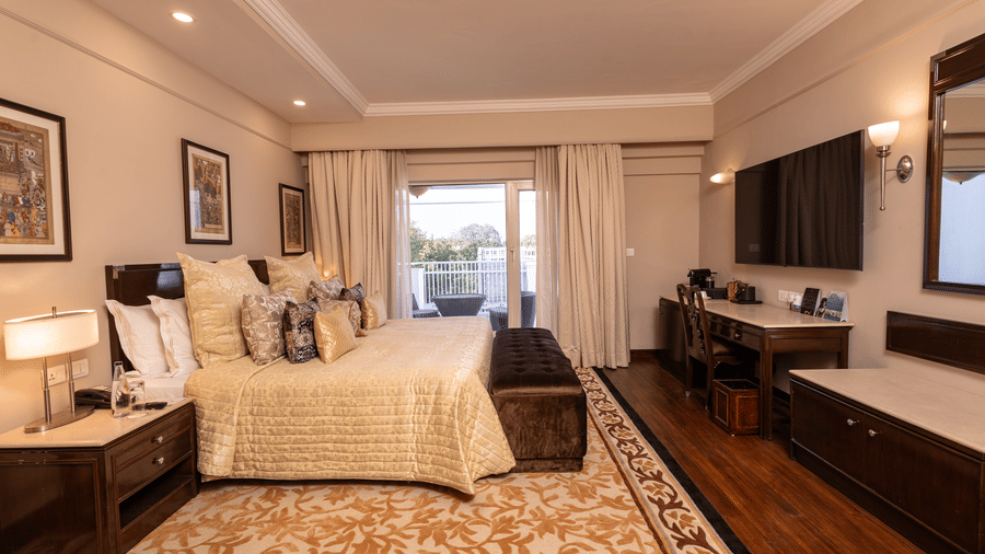 image of a spacious and an elegant bedroom of the heritage terrace room - The Claridges New Delhi