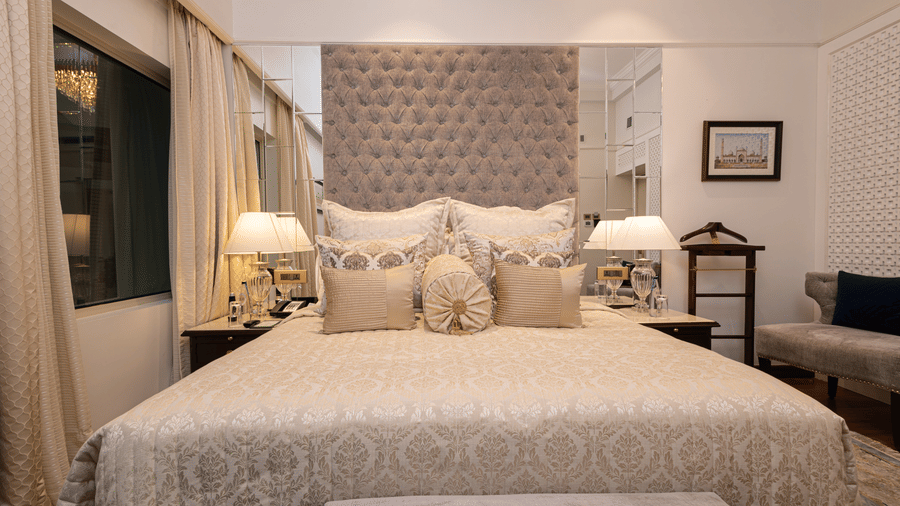image of a plush king size bed with cushioned headboard at our boutique room - The Claridges New Delhi