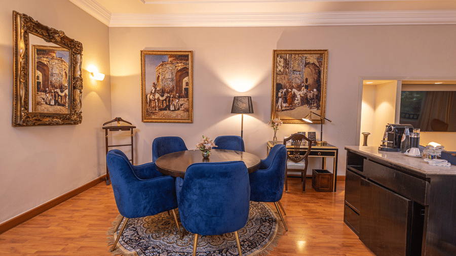 image of a spacious dining area in our regent suites with a round table - The Claridges New Delhi