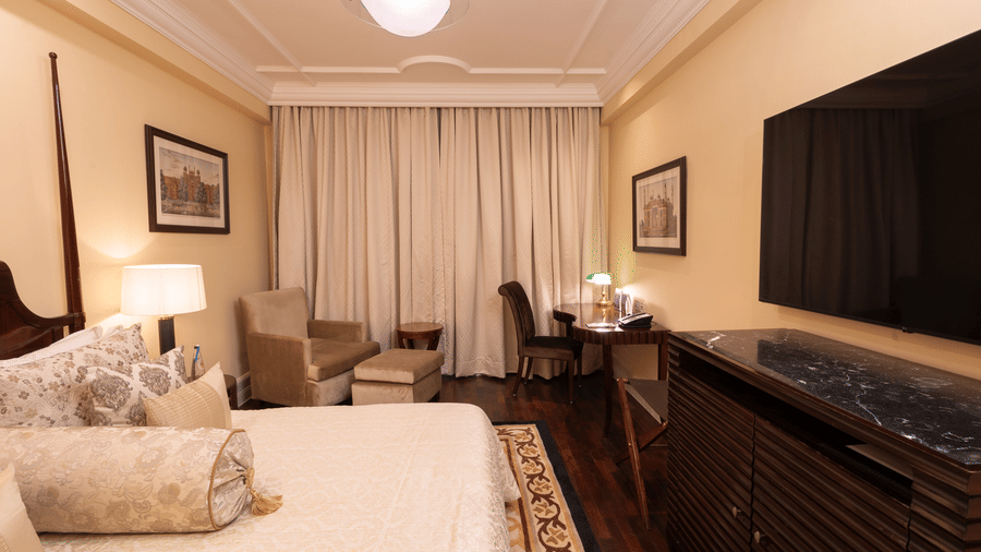 full view of the heritage parlour room with a wall mounted tv - The Claridges New Delhi