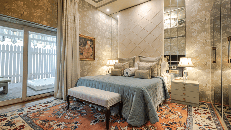 image of the bedroom with a vibrant carpet under the bed at our heritage luxury suite - The Claridges New Delhi