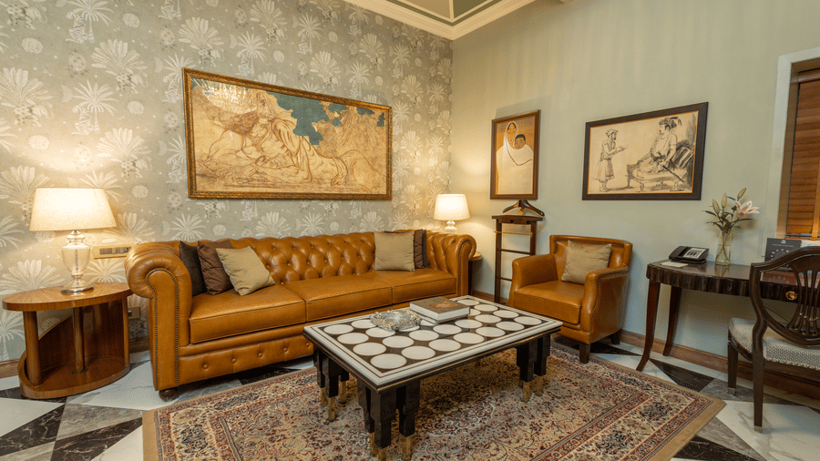 image of the living room at our heritage luxury suite with occur brown couch and a coffee table - The Claridges New Delhi