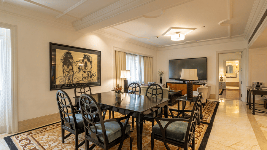image of the living area with the dining table from a corner angle at the viceroy house estate suite - The Claridges New Delhi