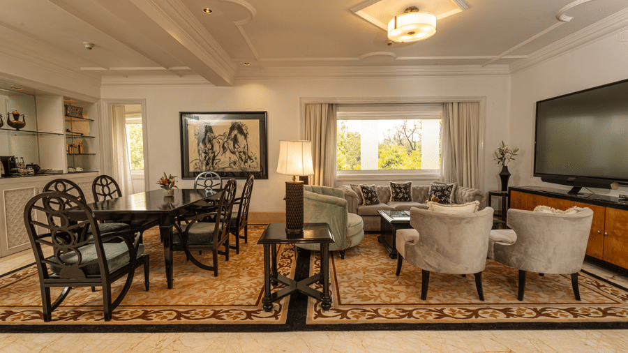 full view of the living area with the dining table and the family seating area at our viceroy house estate - The Claridges New Delhi