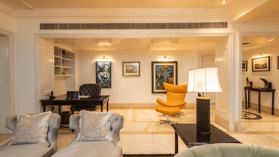 image of the study area with a yellow arm chair at our viceroy house estate suite - The Claridges New Delhi