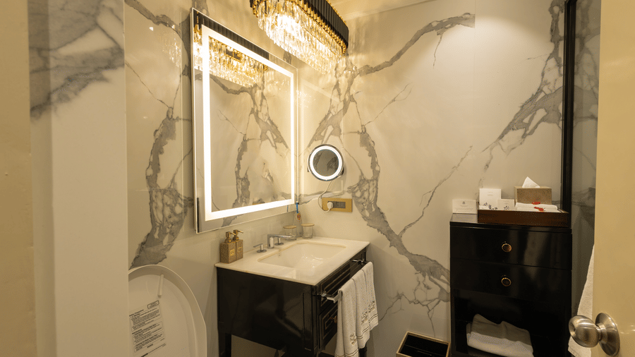 Superior Room washroom at The Claridges New Delhi, featuring a sleek sink and a wall-mounted mirror