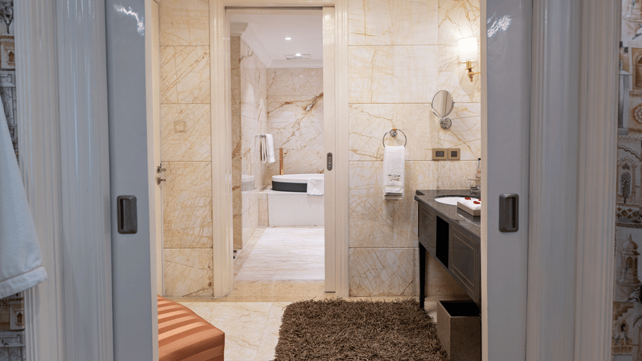image of a classic bathroom with a brown carpet at the entrance at our willingdon crescent suite  - The Claridges New Delhi
