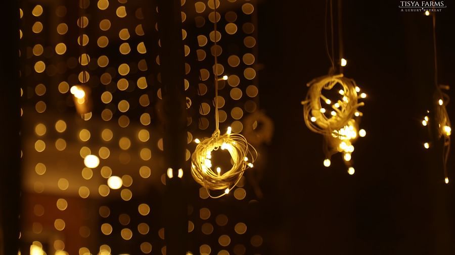 Decorative string lights and floral hangings at night at Tisya Farms, Gurgaon.