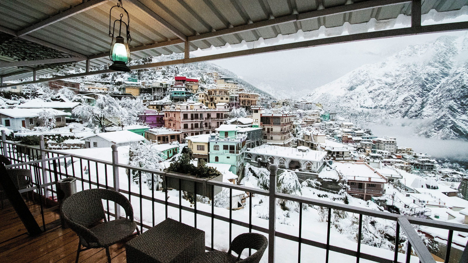 image of the city views on a snowy day with a think blanket of white snow covering everything - The Tattva, Joshimath