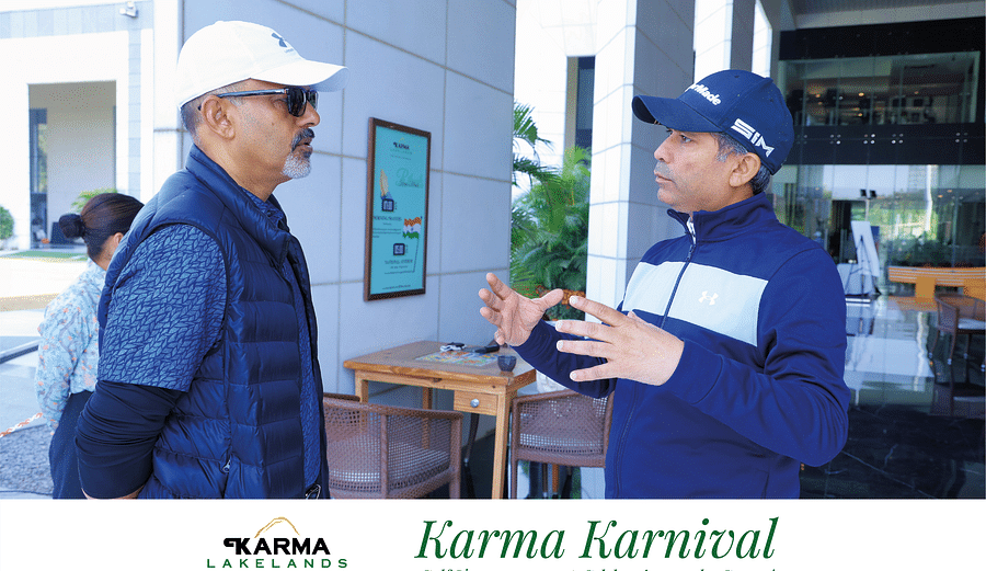 Two participants engaged in conversation near the event area during the Karma Karnival.