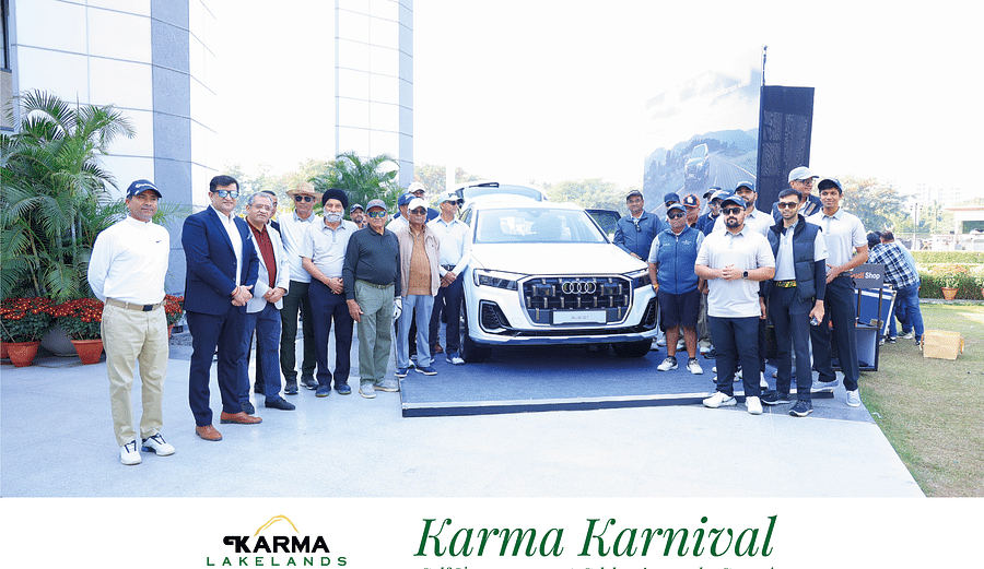 People posing for the picture along with a car at Karma Lakelands-Karma Karnival event